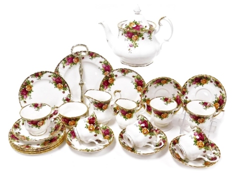 A Royal Albert Old Country Rose porcelain part tea service, comprising a teapot, two graduated cream jugs, sugar bowl, cake stand, six teacups, saucers and plates.