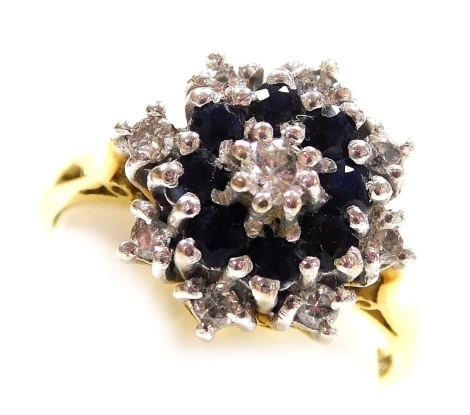 An 18ct gold sapphire and diamond flower head ring, in a basket setting, size O, 6.5g.