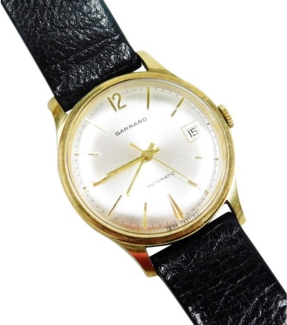 A Garrard gentleman's gold cased wristwatch, circular silvered dial with gold batons, centre seconds, date aperture, automatic movement, the case presentation engraved 'Ruston Gas Turbines Limited, A. Campling 1952-1977 Jubilee', on a leather strap, cased