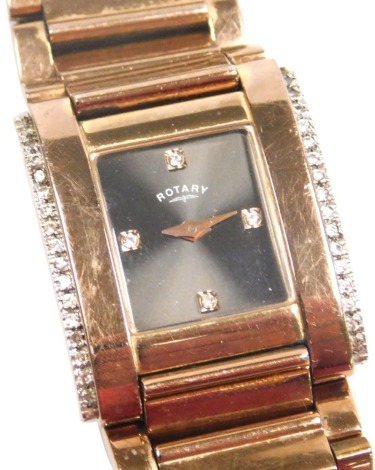 A Rotary rose gold plate on stainless steel lady's wristwatch, of tank form, rectangular black dial, the rounded case bordered by paste set sides, on a bracelet strap.