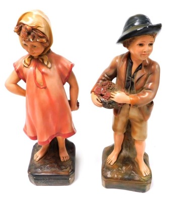 A pair of 1930's chalkware figures, a young girl and boy, each 47cm high.