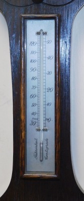 An early 20thC oak cased wheel barometer, with thermometer, the case with foliate carving, 71cm high. - 3