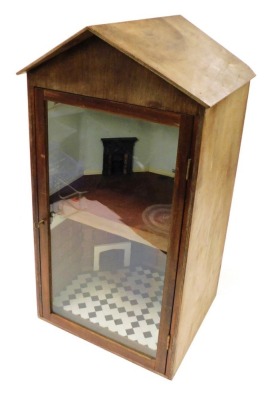 A plywood display case, formed as a two storey building of two rooms, with a glazed door, with key, 74cm high x 44cm wide x 39½cm deep.