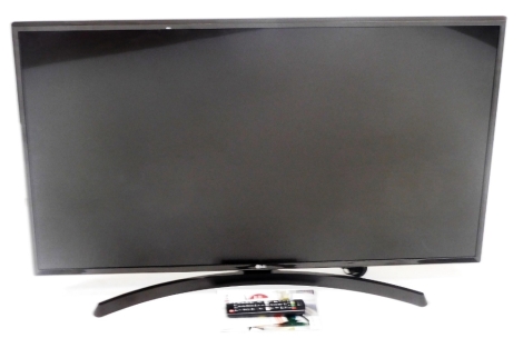 An LG 43" flat screen television, LG43UK6400PLE, with remote and instructions.