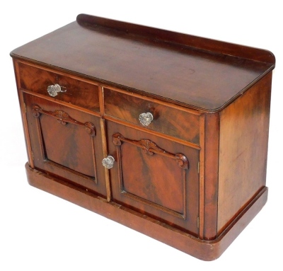 A Victorian mahogany side cupboard, with two drawers over a pair of panelled doors, raised on a plinth base, 77cm high, 111cm wide, 50cm deep.