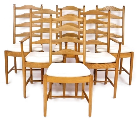 A set of six Ercol elm ladder back dining chairs, with slatted and loose cushion seats, raised on turned legs united by a H framed stretcher, comprising pair of carvers and four single chairs.