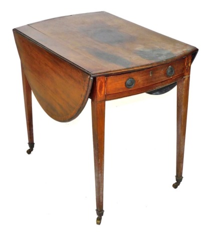 A George III mahogany satinwood crossbanded and boxwood line inlaid Pembroke table, with single frieze drawer raised on tapering square legs, brass capped on castors, 72cm high, 79cm wide, 54cm deep, 118cm extended.