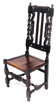 A 19thC Carolean style oak chair, with a crown and leaf scroll carved crest rail, two similarly carved and two similarly carved splats, flanked by barley twist supports, above a solid seat, on square carved and turned legs, with an H frame stretcher and c