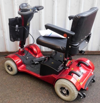 A Sterling Sapphire 2 mobility scooter, in red trim, with charger and cables.