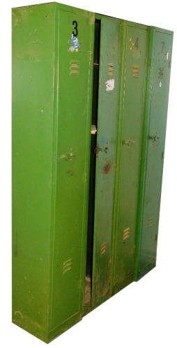 Four green metal lockers, the hinged doors enclosing an arrangement of shelves, each 183cm high, 31cm wide, 30cm deep.