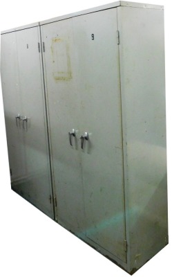 A pair of grey metal two door cabinets, with an arrangement of shelves, 181cm high, 88cm wide, 45cm deep.