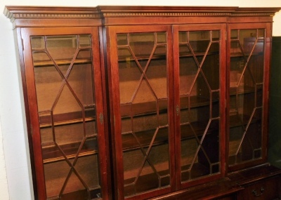 A 20thC mahogany breakfront display cabinet, the top with a moulded dental cornice, above four astragal glazed doors enclosing an arrangement of shelves, the base with four drawers and four cabinets, on a plinth base, 197cm high, 164cm wide, 55cm deep. - 2