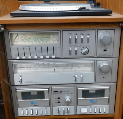 An Amstrad music system, with turntable, stereo tuner, double cassette deck, stereo amplifier, in case, 86cm high, 43cm wide, 38cm deep, together with a pair of speakers. - 3