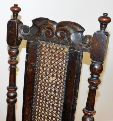 A late 17thC oak and walnut high back chair, with a scroll carved crest rail, cane back, flanked by turned uprights, cane seat, raised on turned legs united by two upper turned stretchers and an H framed stretcher below, 120cm high. - 2