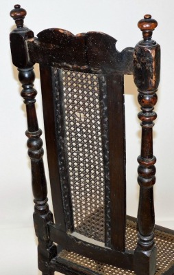 A late 17thC oak and walnut high back chair, with a scroll carved crest rail, cane back, flanked by turned uprights, cane seat, raised on turned legs united by two upper turned stretchers and an H framed stretcher below, 120cm high. - 3