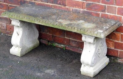 A composition bench, of rectangular form, with carved border, on two scroll supports, 50cm high, 117cm wide, 44cm deep.