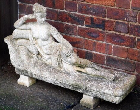 A composition garden statue after Canova, depicting the Princess of Borghese reclining on a sofa, 58cm high, 87cm wide, 36cm deep.