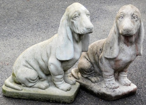 A pair of composition garden figures, of bloodhounds, each 49cm high.