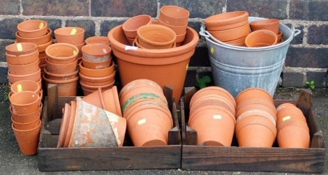 A group of terracotta plant pots, various sizes, the largest 12cm high.