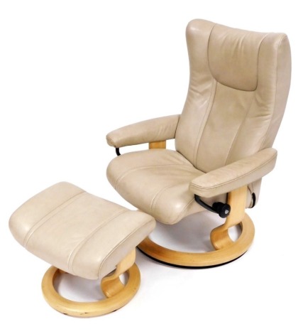 An Ekornes Stressless cream leather armchair, and matching footstool, the chair 78cm wide.