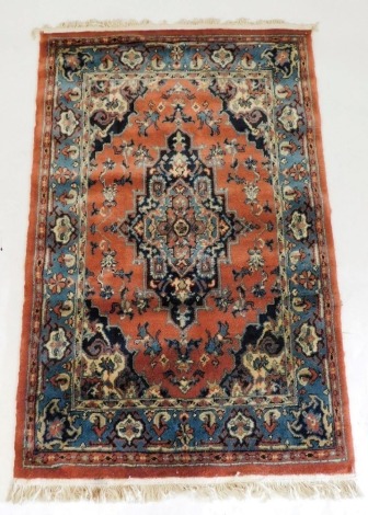 A Persian Keshan rug, decorated with a central medallion, flowers and scrolling foliage, within repeating floral borders, 142cm x 93cm.