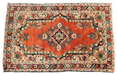 A Turkish red ground rug, decorated with a central floral medallion, the field with further flowers and scrolling leaves, within a repeating floral border, 193cm x 123cm.