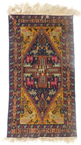 An Afghan black ground rug, decorated with exotic animals, birds, helicopters, figures and flowers, within repeating bird and floral borders, 195cm x 105cm.