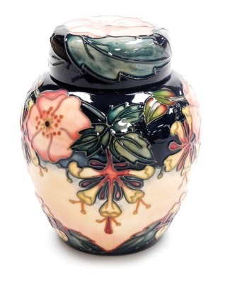 A Moorcroft pottery Oberon pattern ginger jar and cover, impressed marks and signed to underside, 16cm high.