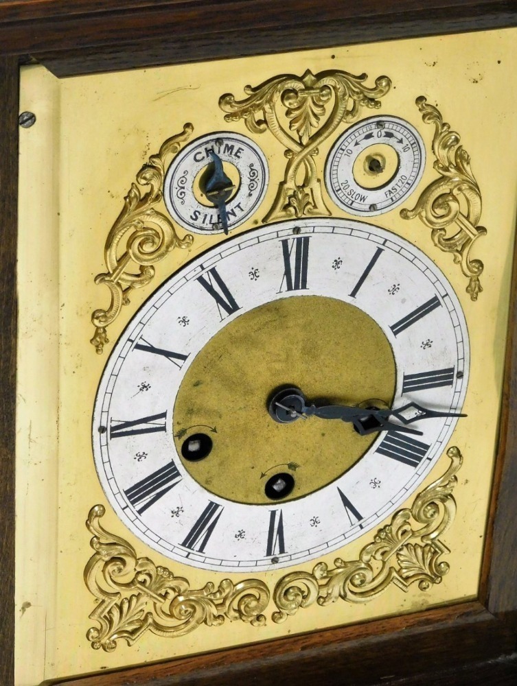 An early 20thC Junghans oak cased mantel clock, rectangular brass dial