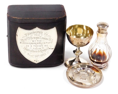 A Victorian silver communion set, comprising a challis engraved with the christogram 'For Jesus' within a star burst frame, similar salver for wafers, and a cut glass bottle with silver lid, engraved DBE, cased, with silver shield plaque engraved 'Present