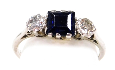 A platinum sapphire and diamond three stone ring, with a square cut sapphire flanked by a pair of brilliant cut diamonds, diamonds approx ½ct, size N, 3.4g.