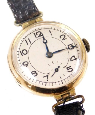 An early 20thC lady's 15ct gold cased wristwatch, circular silvered dial bearing Arabic numerals, subsidiary seconds dial, the case back monogram engraved and dedicated 'From Father 20 April 1919', on a leather strap.