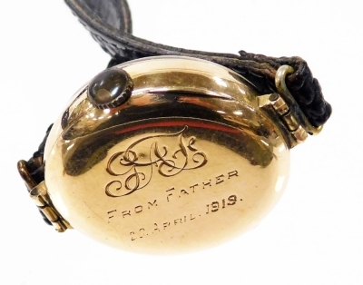 An early 20thC lady's 15ct gold cased wristwatch, circular silvered dial bearing Arabic numerals, subsidiary seconds dial, the case back monogram engraved and dedicated 'From Father 20 April 1919', on a leather strap. - 3