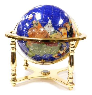 A hard stone terrestrial globe, in a brass gimbal table frame, frame 45cm wide.