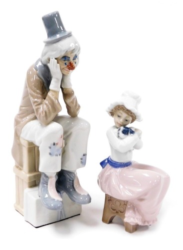 A Lladro porcelain figure of a Pierrot, modelled seated with his head in his hands, together with a Nao figure of a girl with a puppy seated on a stool. (2)