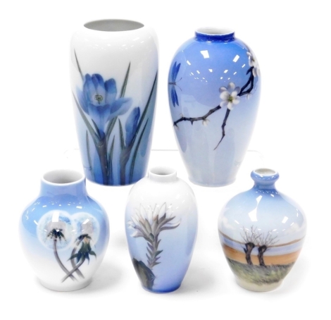 A group of Royal Copenhagen and porcelain vases, one decorated with a coastal landscape, the others with flowers and blossom, printed and painted marks. (5)