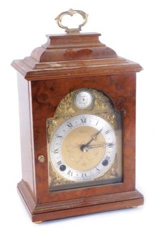 An Edwardian walnut Mundsey & Co of Cambridge Elliott mantel clock, the burr walnut case with brass dial with silvered Roman numeric chapter ring, on bun feet, 28cm high, 16cm wide, 11cm deep.