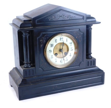 A 19thC black slate mantel clock, cream enamel numeric dial and brass chapter ring, eight day movement with coil strike, the case of architectural form, raised on a stepped base, 32cm high, 35cm wide, 15cm deep.