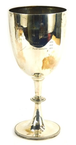 A Victorian silver trophy cup, The Challenge Cup for Brown Leghorn Hen or Poulet, bearing the initials R H W, won York 1892, Norwich 1893 and Portsmouth 1896, on a ribboned stepped foot, London, 32cm high, 23¾oz.