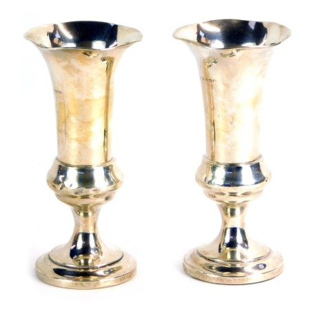 A pair of Edward VII silver fluted vases, each with a fluted rim, on weighted base, Birmingham 1907, 8½oz gross.