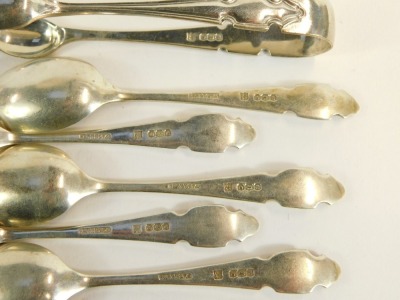 A cased partial set of teaspoons and sugar tongs, each with a shield top, Sheffield 1922, one teaspoon lacking, 2½oz, in fitted case. - 3