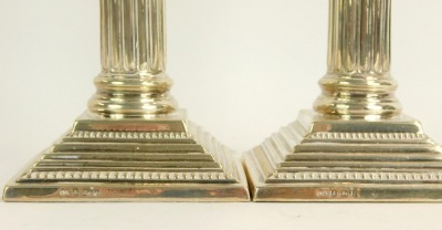 A pair of silver taper candlesticks, each on Corinthian column with scroll design, and vine top, on loaded bases, maker A S, Birmingham 1968, 21oz gross. - 2