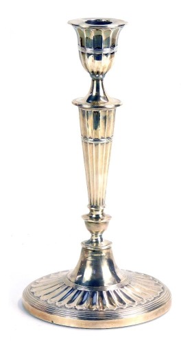 A Victorian silver candlestick, of tapered form on oval weighted base, London 1888, 8cm high, 29oz gross.