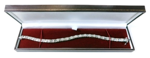 A diamond line bracelet, set with alternate set of baguette and round brilliant cut diamonds, on long bracelet, set in 9ct white gold, diamonds totalling 5.75ct, 21cm long, 20.4g all in.