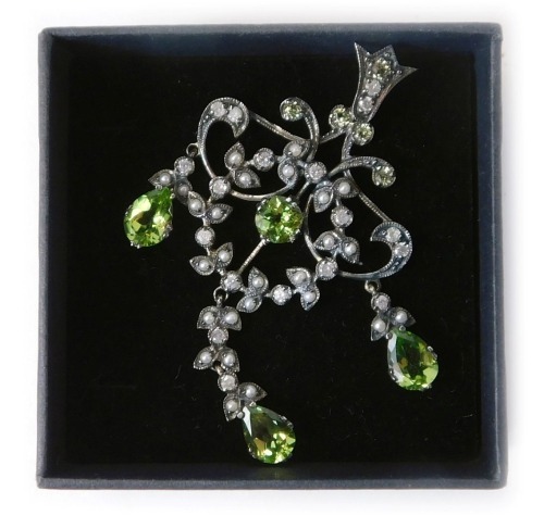 110 - An Edwardian chandelier style pendant, set with seed pearls, diamonds and peridot, mixture of round peridot and pear cut, with three suspended drops, in a yellow and white metal frame, unmarked, 5.5cm high, 4.4g all in.