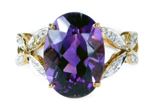 120 TOP JLS - A 9ct gold amethyst and diamond dress ring, with large oval amethyst, approx 5ct, in a four claw setting, with X wing diamond set shoulders, totaling approx 0.027ct, raised basket setting with V splayed shoulders, on plain band, size N½.