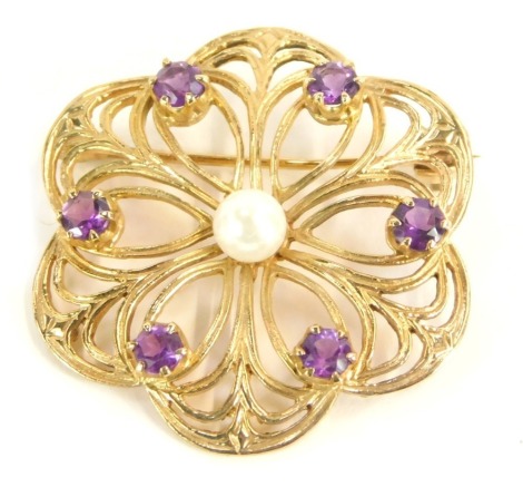 A 9ct gold brooch, formed as a flower, with pierced outer design, set with six amethyst and central cultured pearl, 3.5cm diameter, 7.5g all in.