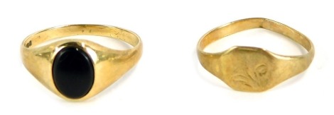 Two 9ct gold signet rings, comprising one set with black onyx, size K½, and another with engraved rectangular paneled design, size J, 2.7g all in. (2)