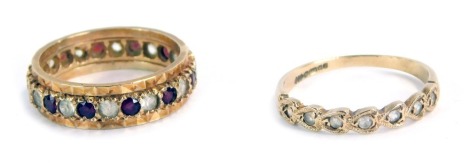 Two dress rings, comprising a 9ct gold CZ set half hoop dress ring, size N½, and a 9ct gold CZ and garnet set eternity ring, size M½, 4.9g all in. (2)