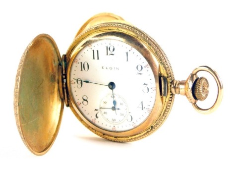An Elgin fob watch, with engraved floral design case, bearing swallow and flowers, with a white enamel numeric dial and seconds dial, in a yellow metal case, unmarked, key wind, 3.5cm wide, 41.7g all in.